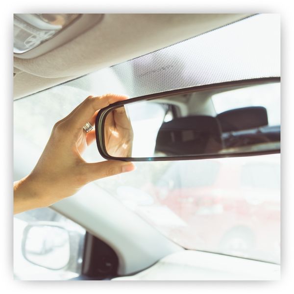 Hand adjusting rearview mirror