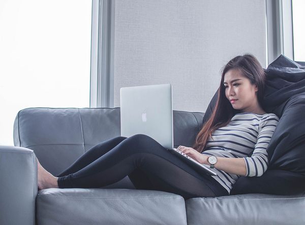 girl taking an online class on the couch