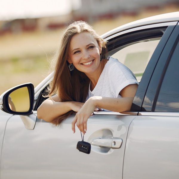 woman leaning out her car window