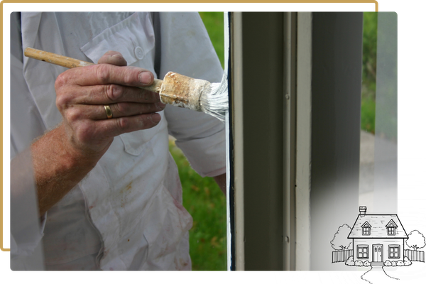 person painting the outside of a window pane