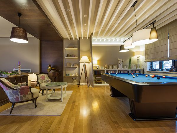 Interior of a luxury living room with pool table.
