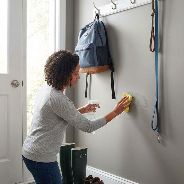 homeowner cleaning high-traffic wall area