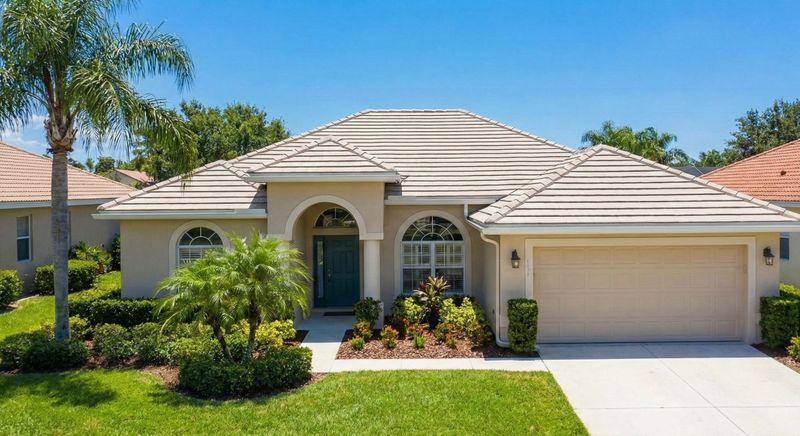 A sunny Florida residential home with a clean, well-maintained roof.