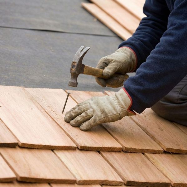 roofer nailing on wood shingles