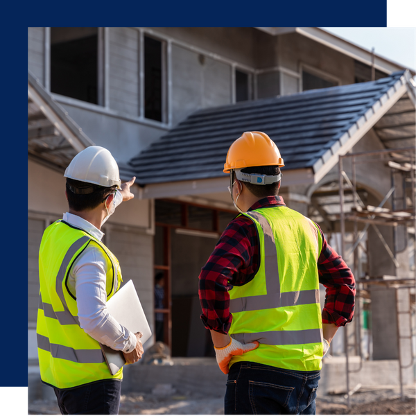 Builders pointing at home under construction