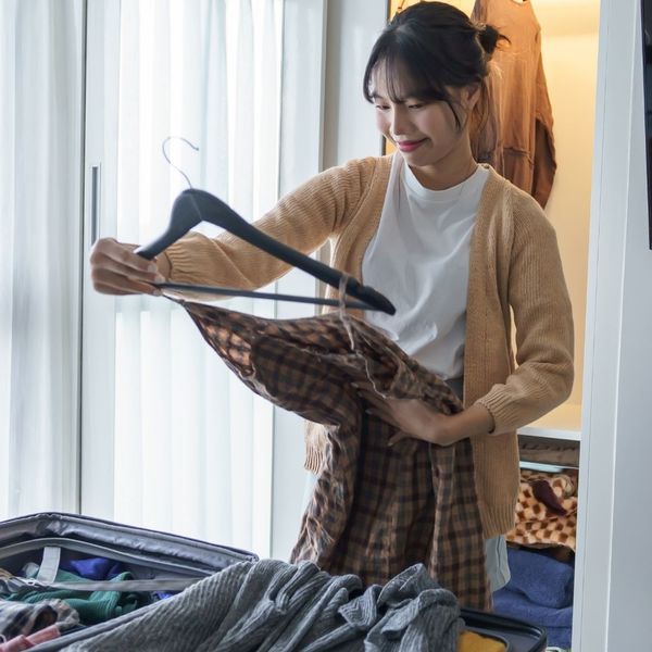 woman unpacking suitcase