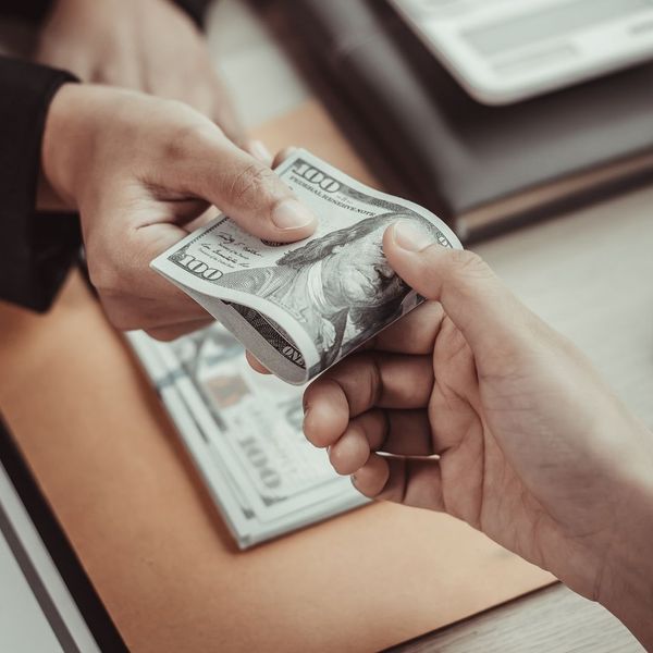 handing over cash