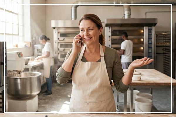 woman in a bakery on the phone