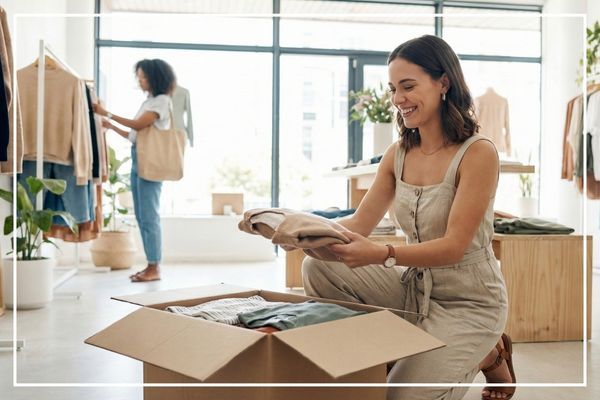 woman opening up box of clothing