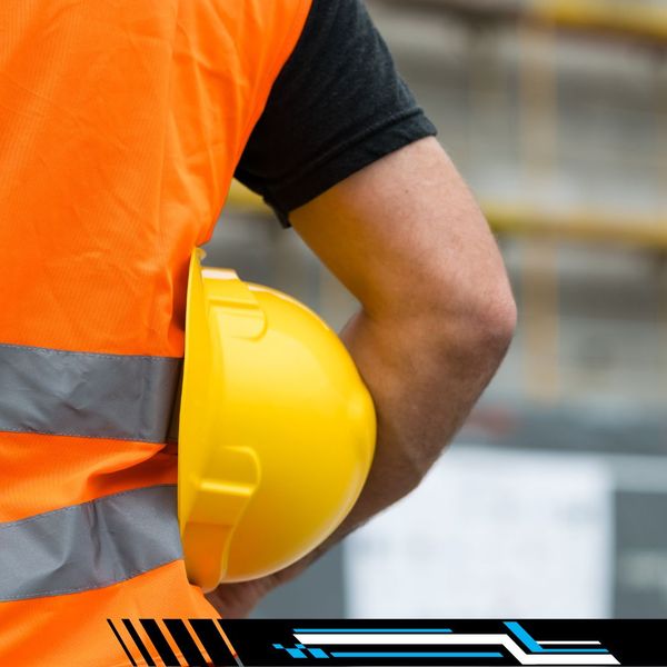 worker holding a safety hat in an orange vest