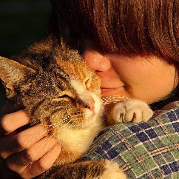 woman hugging her cat