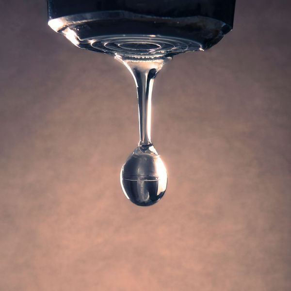 water dropping from a faucet water dropping from a faucet