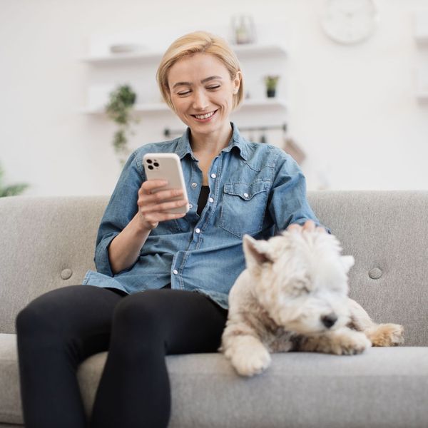 woman sitting with her dog on the couch