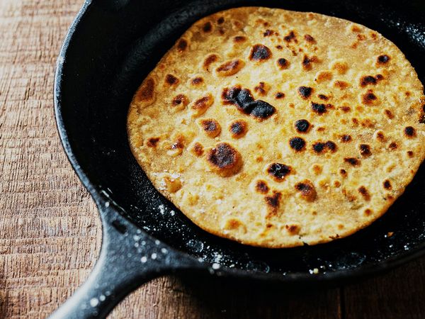 Homemade Jamaican roti flatbread in a pan.