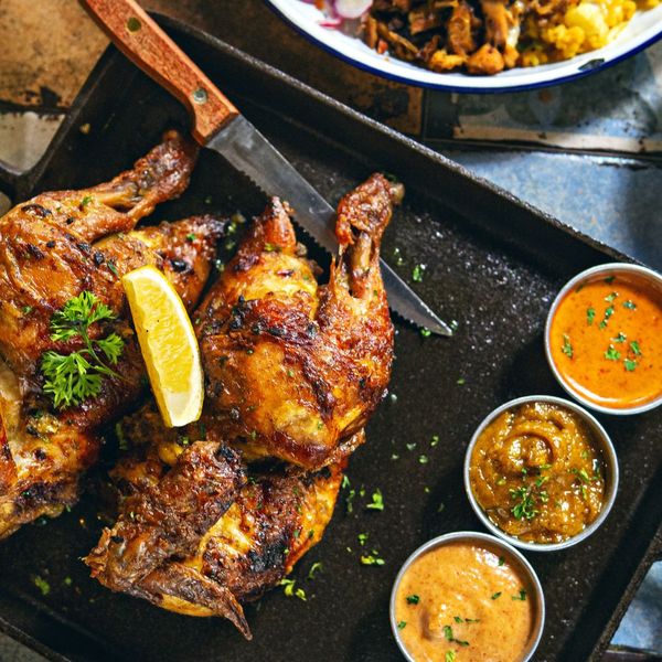 jerk chicken with lemon and various dipping sauces