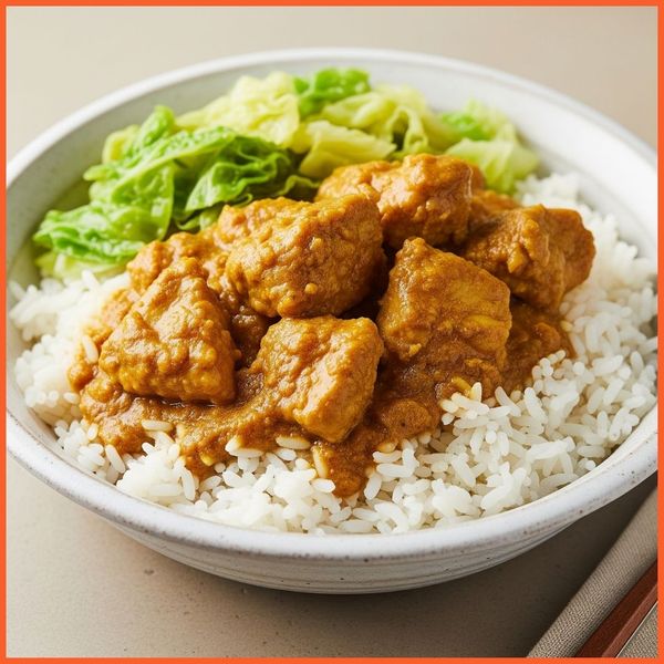 plate of Jamaican curry chicken served with rice