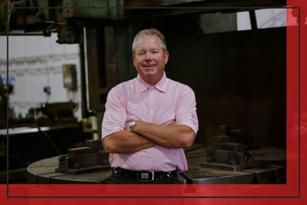 Owner, Bobby Hill, of JAB Services posing with a pink button up shirt and his arms crossed