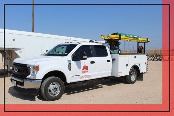 branded white truck for the business JAB services parked outside