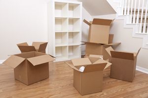 An image of an empty room with several cardboard boxes on the floor