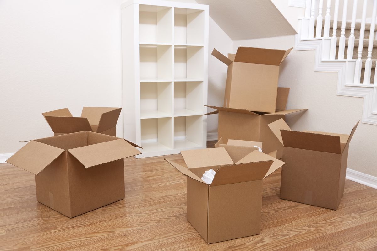 An image of an empty room with several cardboard boxes on the floor