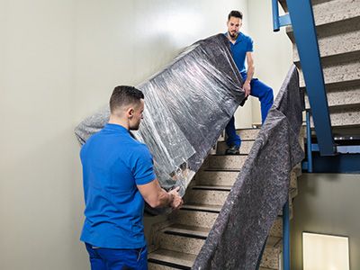 movers moving a heavy couch