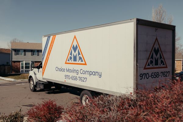 An Image of a moving truck parked outside a home