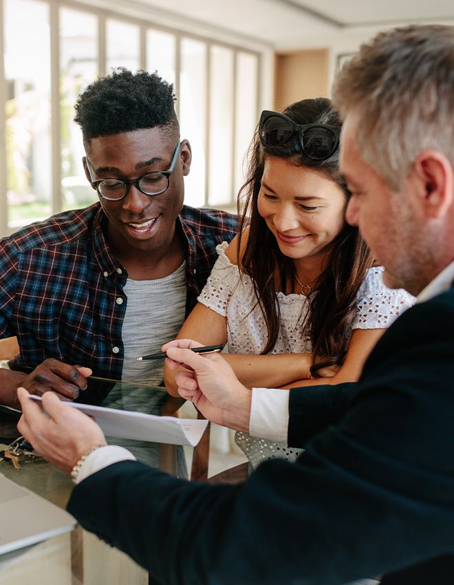 a couple looking at paperwork with a realtor