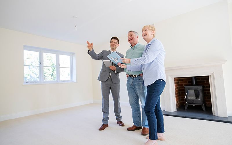 a realtor showing an older couple a home