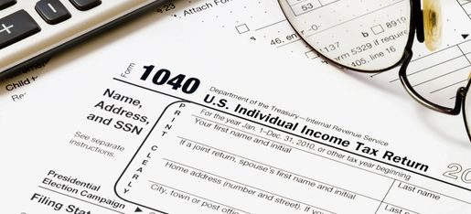 1040 individual income tax return, glasses, calculator