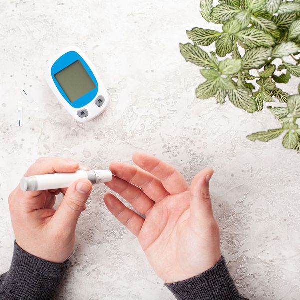 person pricking finger to measure ketone levels