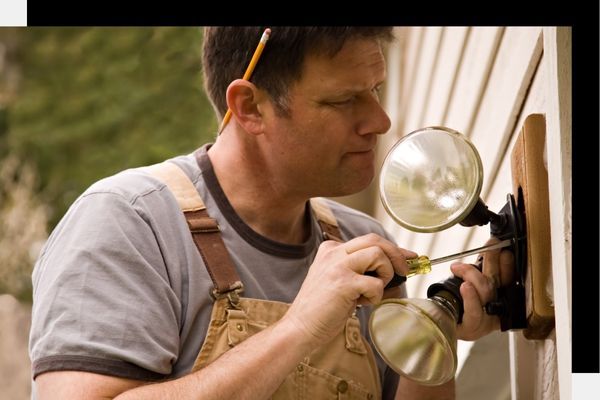 electrician installing outdoor security light electrician installing outdoor security light