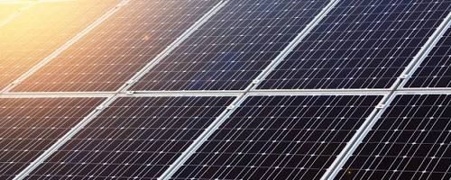 A technician evaluating a home rooftop for optimal solar panel placement and sun exposure.