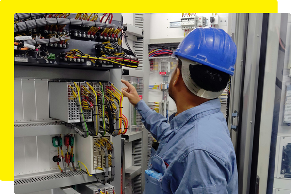 commercial electrician working on electrical panel