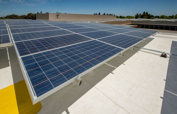 A close-up view of dark, high-efficiency solar panels neatly installed on a roof.