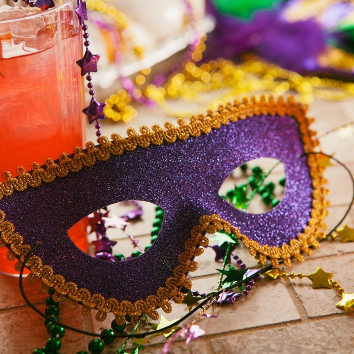 Mardi Gras mask and a drink
