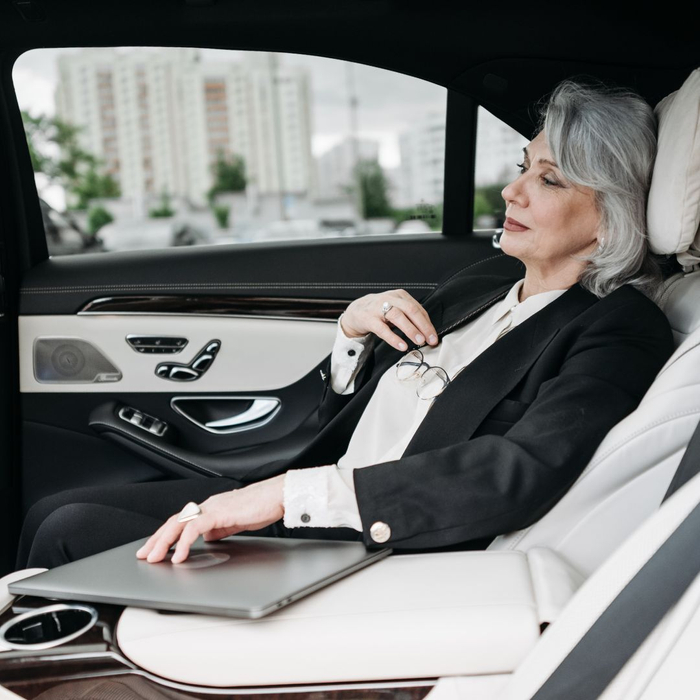 businesswoman relaxing in back of limo