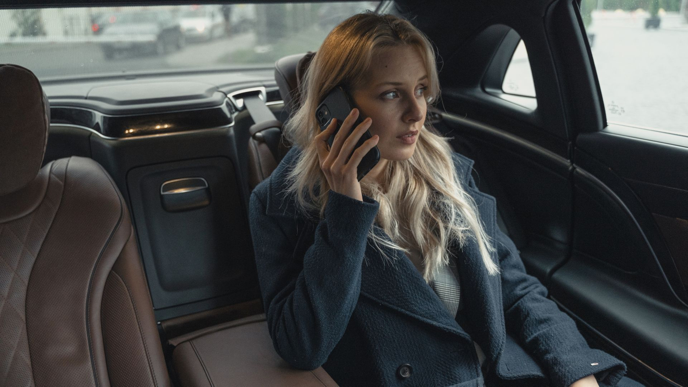 businesswoman in backseat on phone