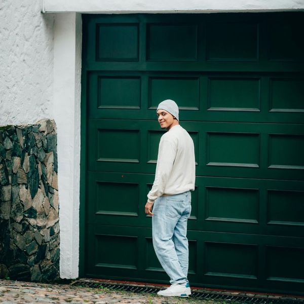 person standing outside of garage