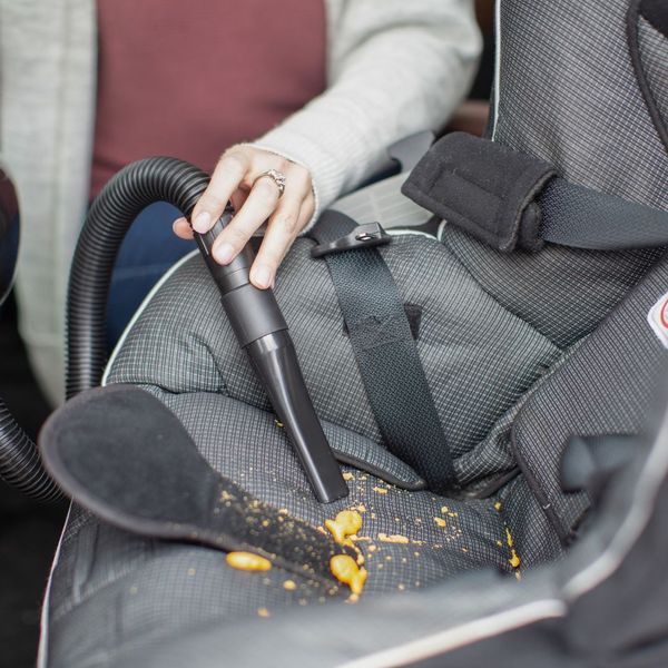 Riccar vacuum cleaning up crumbs from carseat