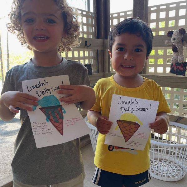Two children with drawings they painted