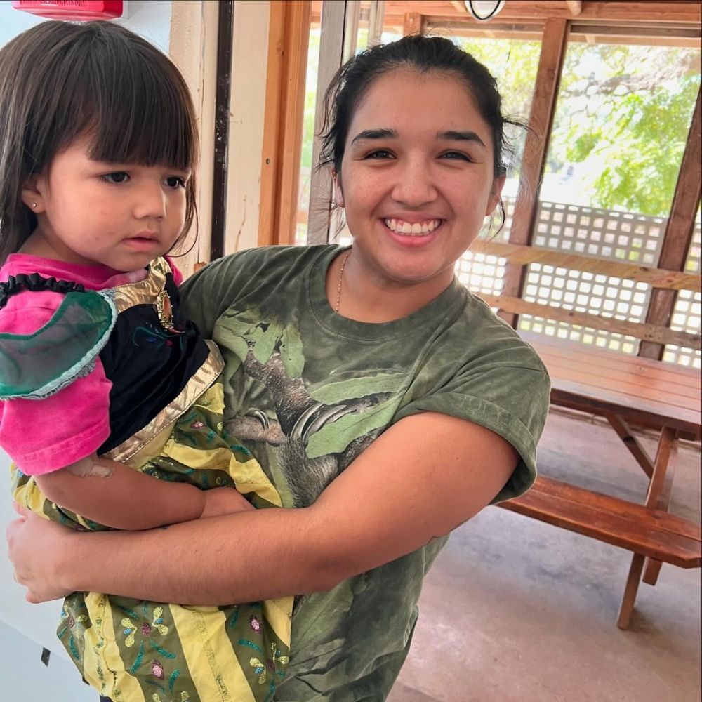 staff holding little girl