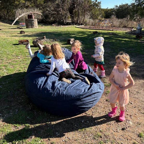 Children jumping on a bean bag