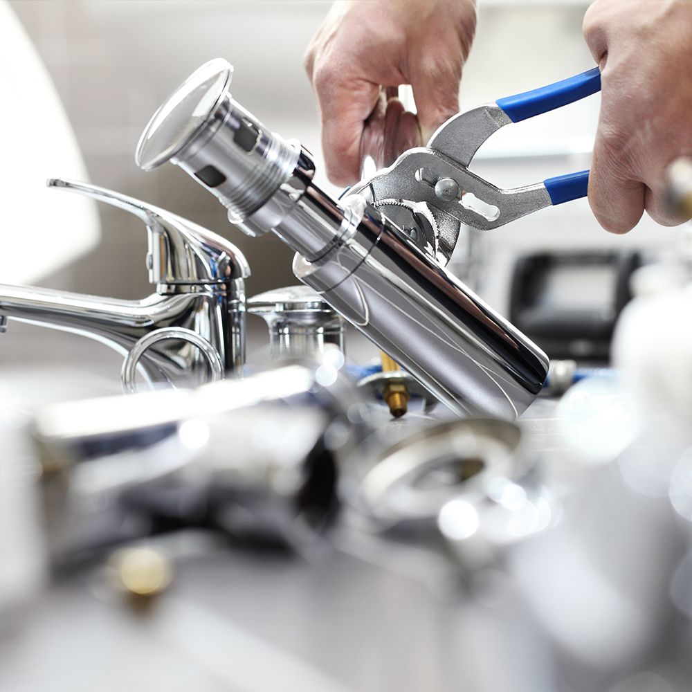 plumber working on sink