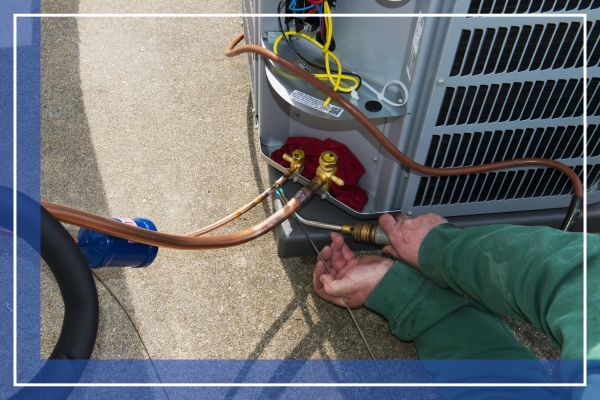 Welding, Install Central Air Conditioner AC Unit. An AC service technician is welding copper tubing during the install of a home central air conditioner unit.