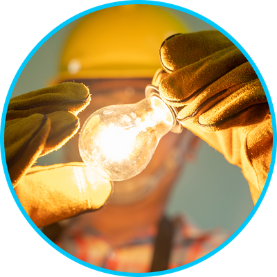 electrician holding lit lightbulb with gloves