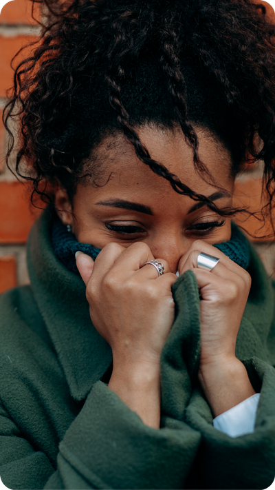 woman crying into hoodie woman crying into hoodie