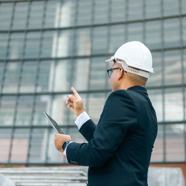 man wearing construction hat outside commercial building