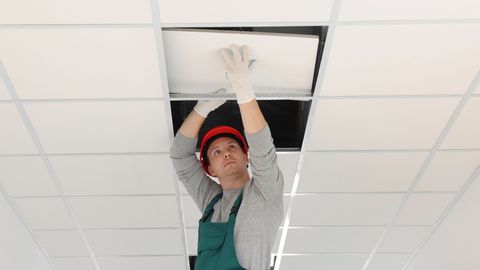 ceiling contractor installing tile