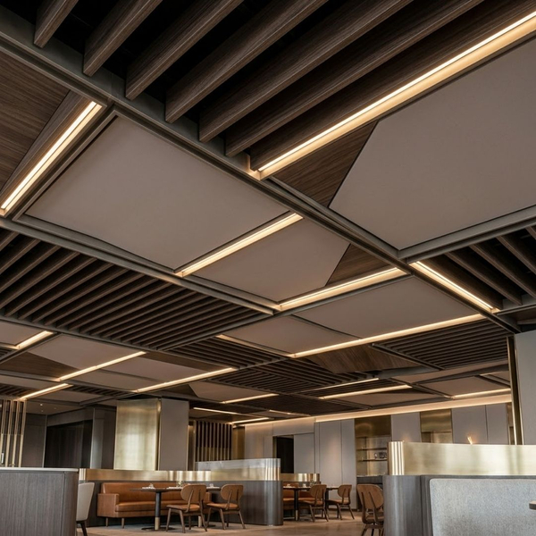 a sophisticated custom ceiling design blending dark wood baffles, modern acoustic panels, and integrated linear LED lighting in an upscale commercial restaurant lounge
