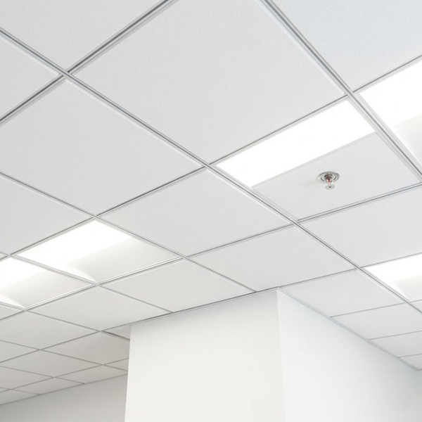 a professional commercial drop ceiling in a bright office, highlighting high-reflectance acoustic tiles and integrated, energy-efficient LED panel lighting, with a code-compliant sprinkler head visible for fire safety integration